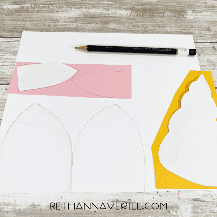 Unicorn ear and horn templates sketched onto colored construction paper.