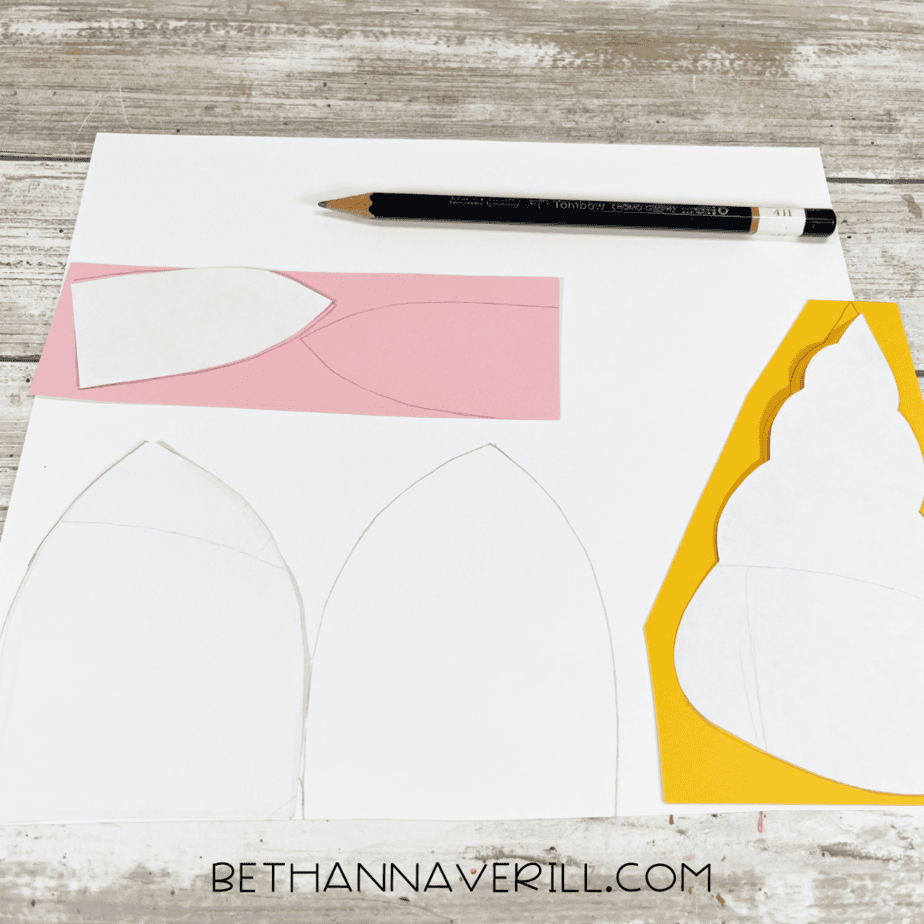 Unicorn ear and horn templates sketched onto colored construction paper.