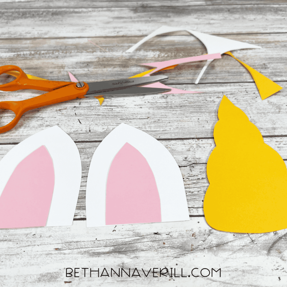 Cut-out unicorn ears with pink inner ear pieces and a yellow horn shape.