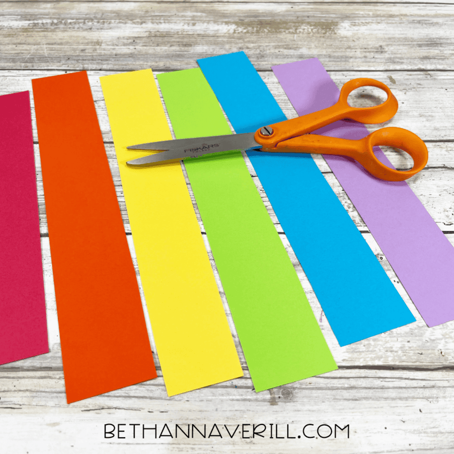 Strips of rainbow-colored construction paper cut out for the unicorn’s mane.