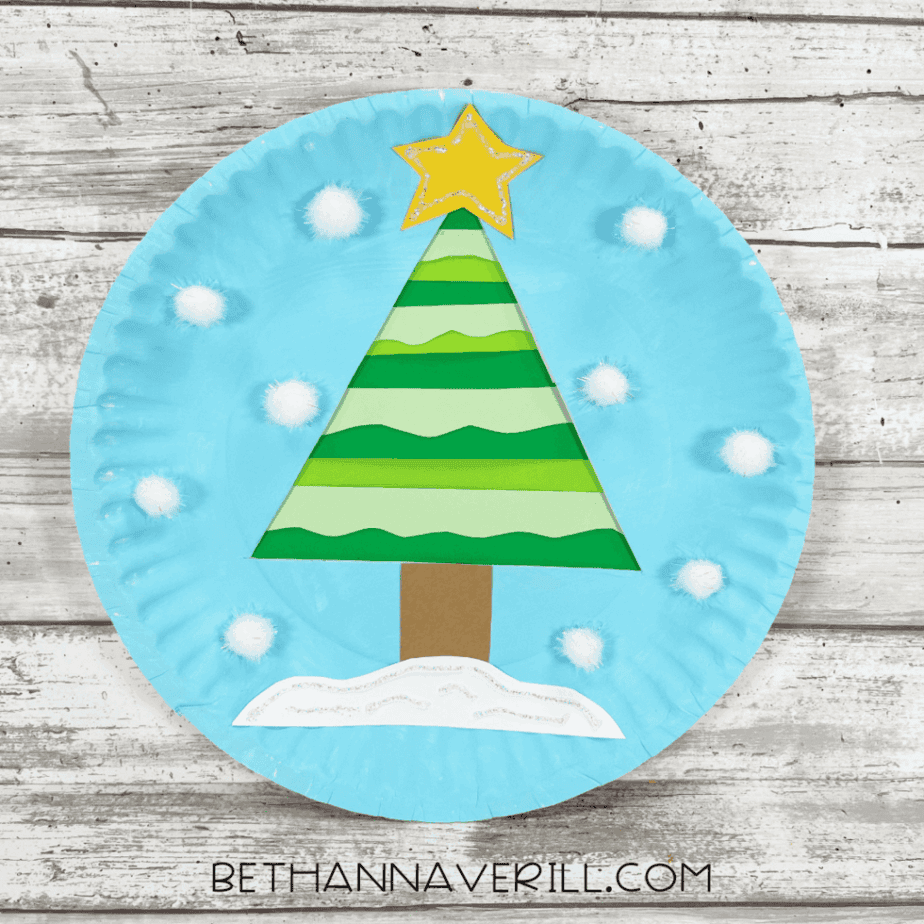 Finished winter tree paper plate craft decorated with cotton snow and paper tree.