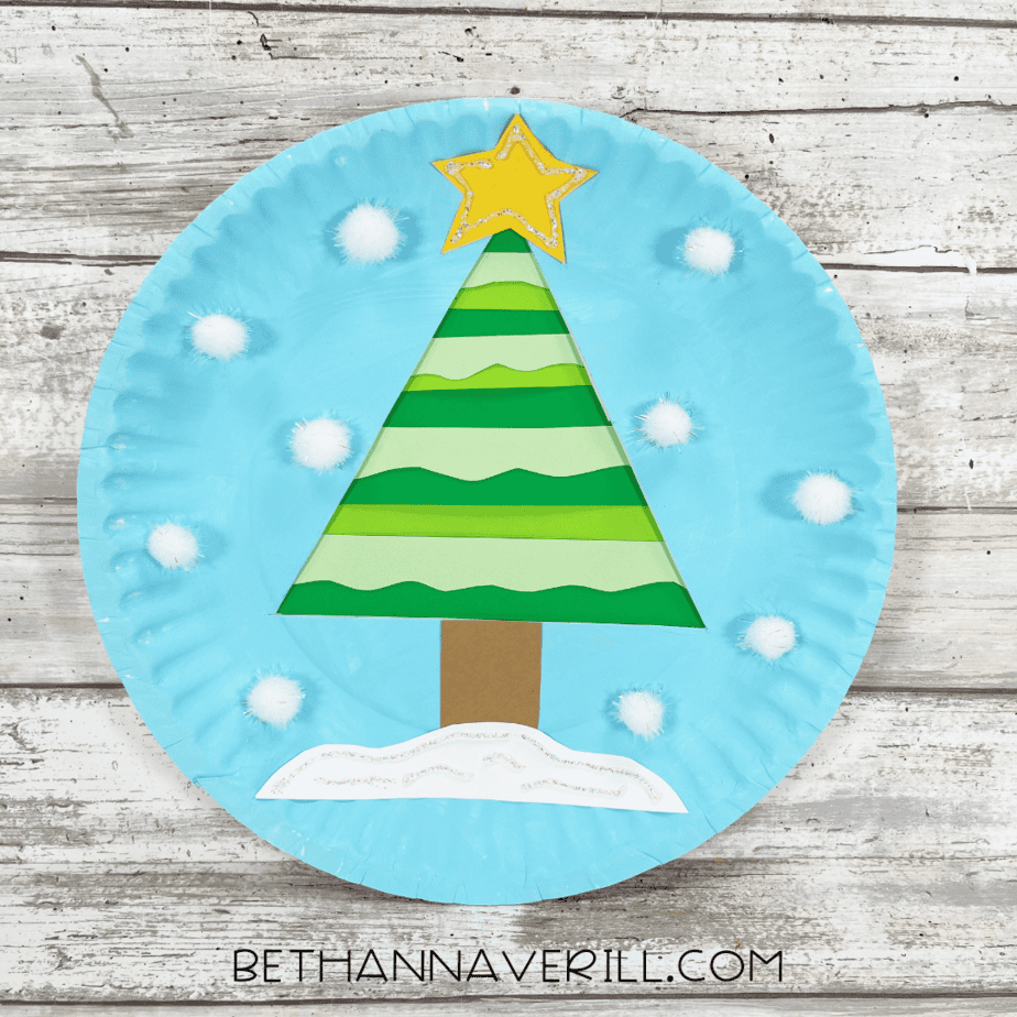 Finished winter tree paper plate craft decorated with cotton snow and paper tree.