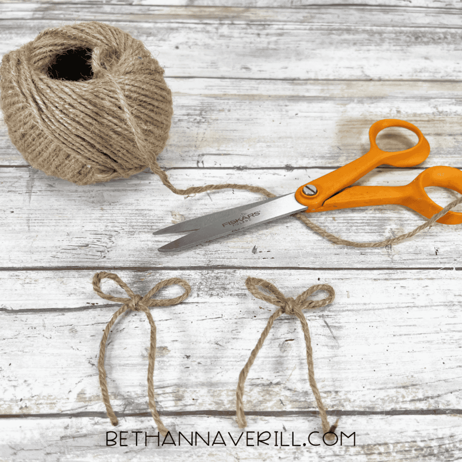 Twine, scissors, and small bows prepared for witch boots.