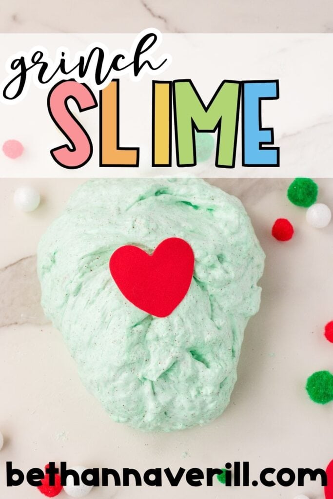 A plop of green Grinch slime with a red heart on top, surrounded by festive pom-poms. The top of the image reads “Grinch Slime” in colorful, playful letters, styled for Pinterest.