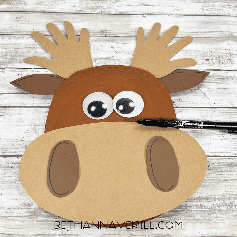 Paper plate moose with details drawn on the ears using a black marker.