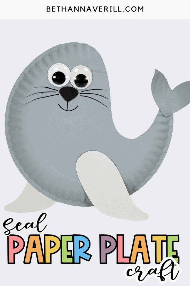 Finished gray paper plate seal craft with big googly eyes, flippers, and a curved tail on a light background.
