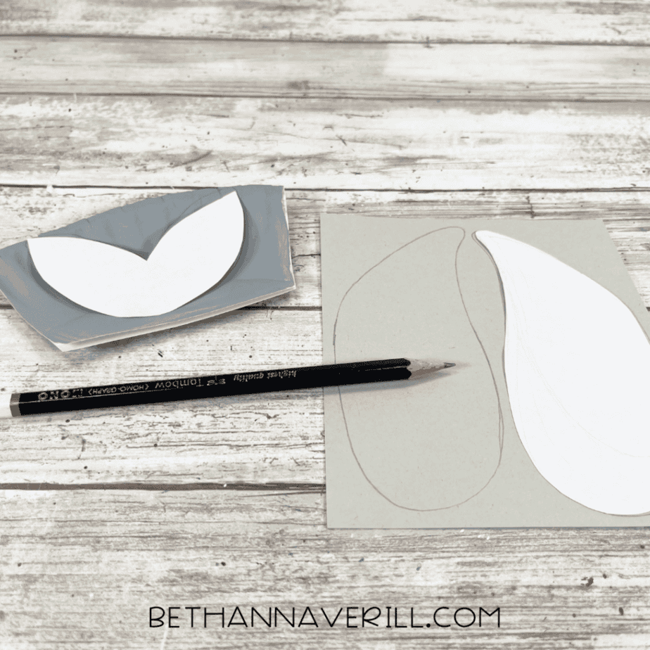 Paper plate craft templates traced onto gray cardstock, showing shapes for the seal’s flippers and tail.