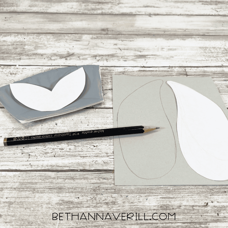 Paper plate craft templates traced onto gray cardstock, showing shapes for the seal’s flippers and tail.