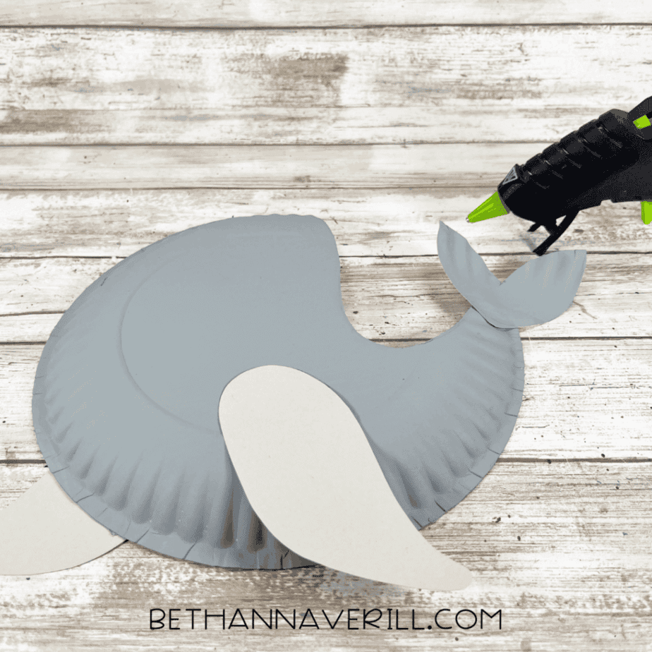 The seal craft partially assembled with flippers and tail glued to the gray paper plate body.