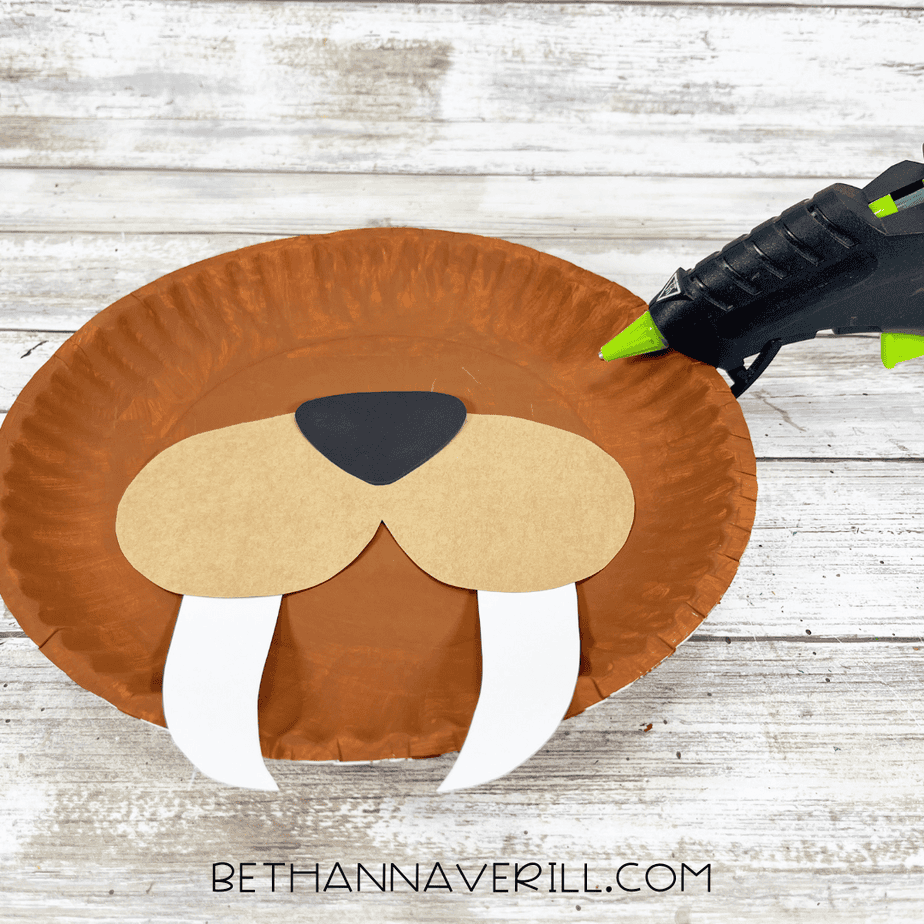 Walrus muzzle, nose, and tusks glued onto the painted brown paper plate.