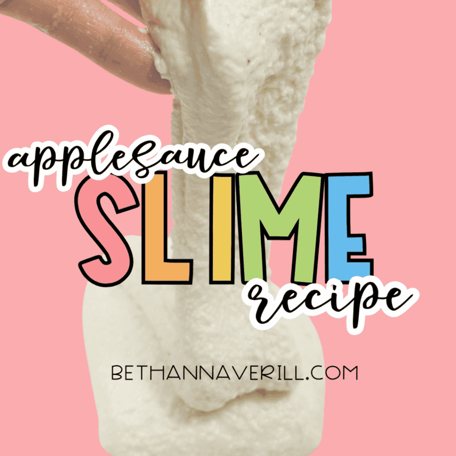 Finished applesauce slime stretched vertically showing smooth, elastic texture.