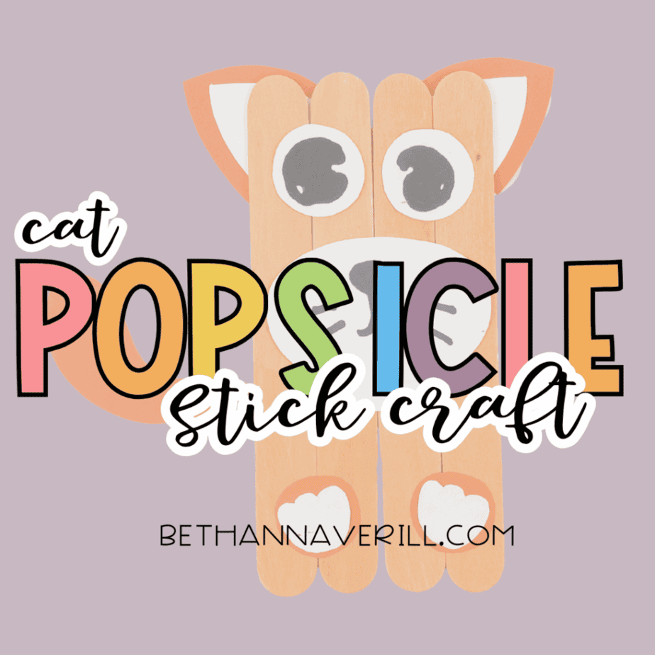 Finished cat popsicle stick craft on a purple background with the text “cat POPSICLE stick craft” overlaid across the image.