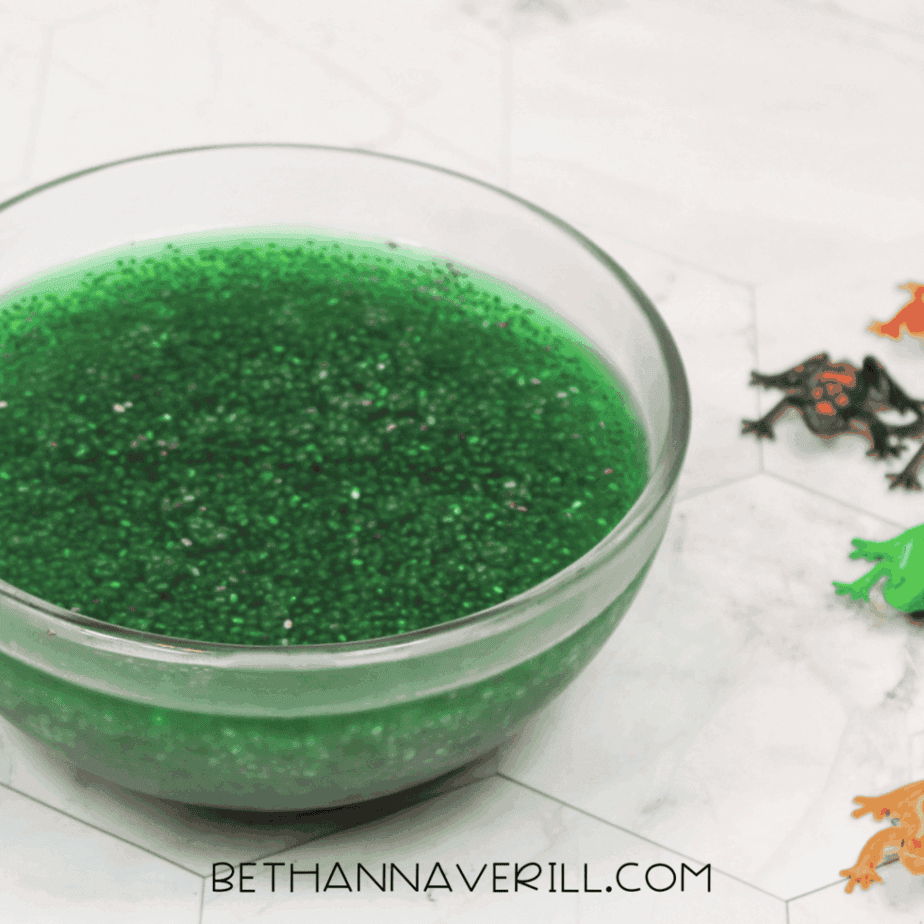 Glass bowl filled with hydrated green chia seeds sitting on a countertop.