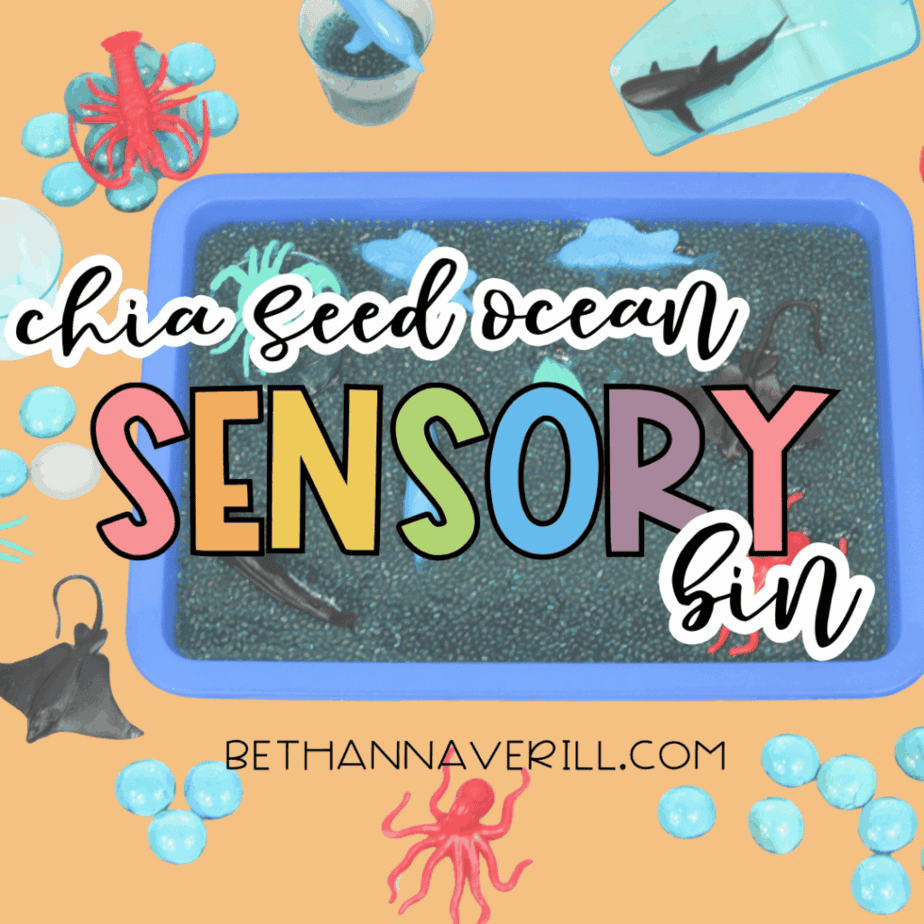 Overhead view of a blue chia seed sensory bin with plastic ocean animals on a peach background with text reading “Chia Seed Ocean Sensory Bin” and “bethannaverill.com.”
