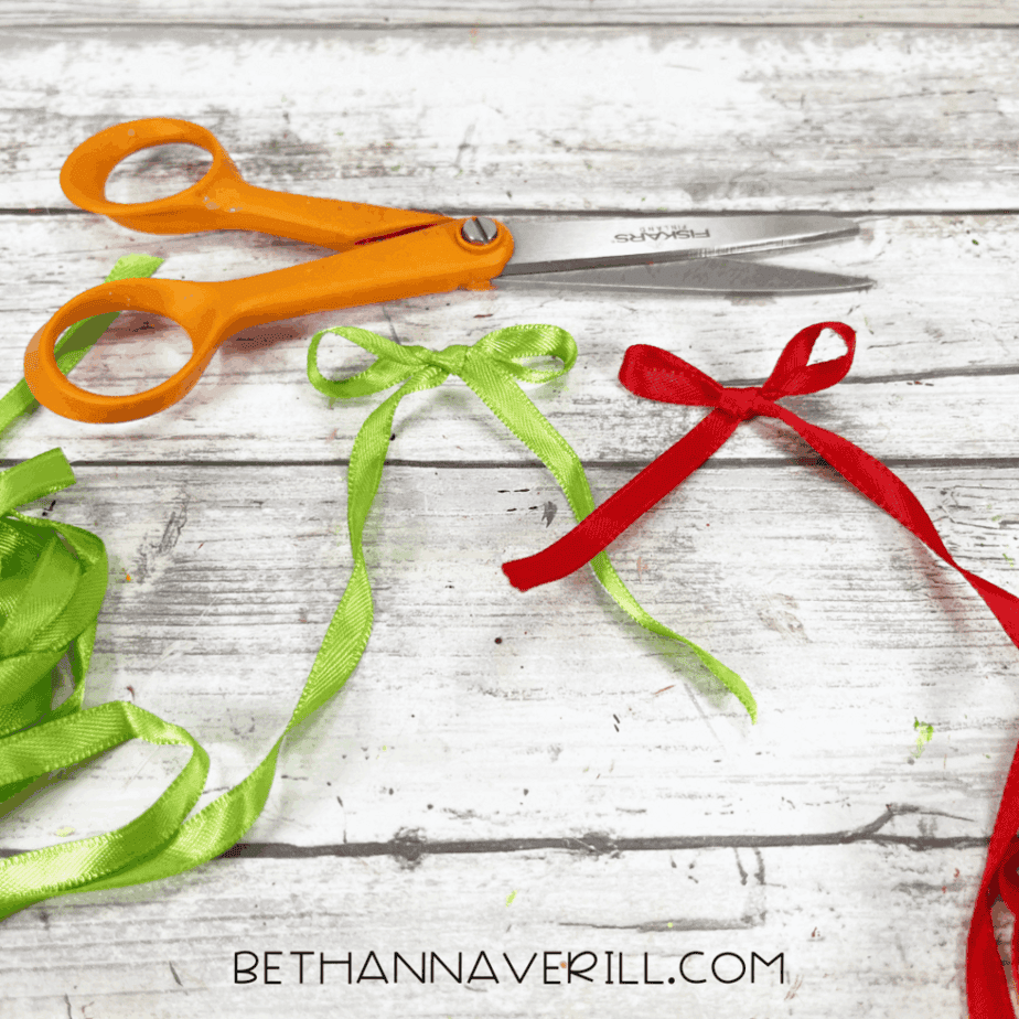Small cardstock labels reading “mail” next to scissors and a black marker
