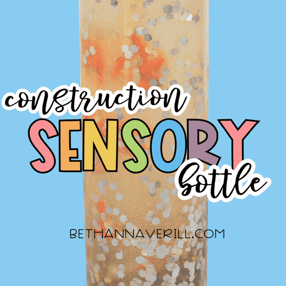 Tall clear sensory bottle filled with glitter, liquid, and orange plastic traffic cones, displayed on a blue background with the text “construction sensory bottle.”