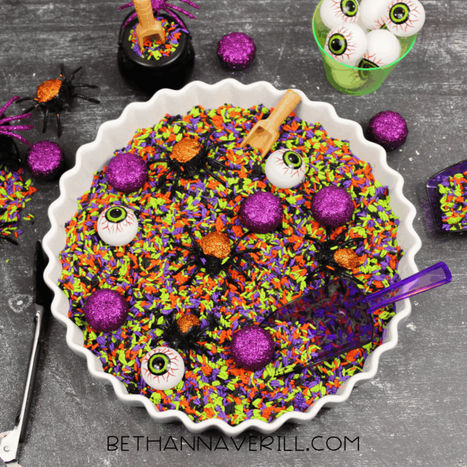 Finished Halloween-colored rice arranged in sections inside a large container showing bright green, purple, orange, and black rice.