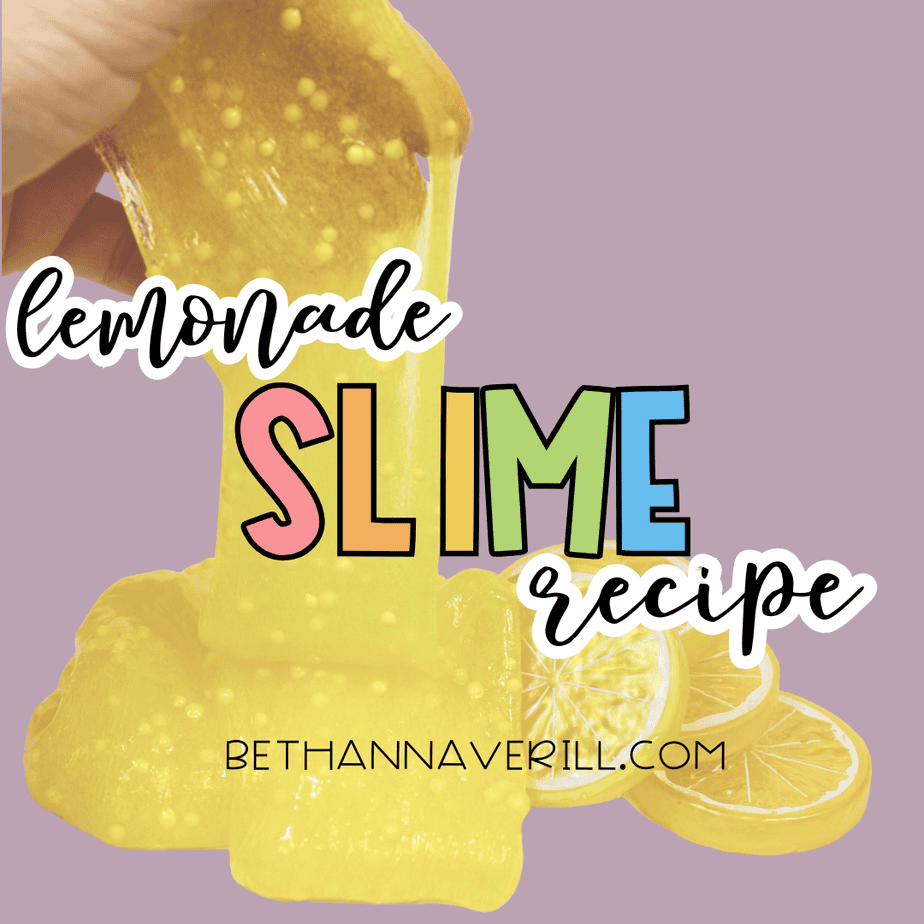 Finished lemonade slime spread on a white surface with lemon slice props for sensory play.