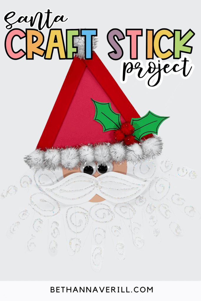 Finished Santa craft stick project featuring a triangle-shaped Santa hat, googly eyes, and glittery white beard.