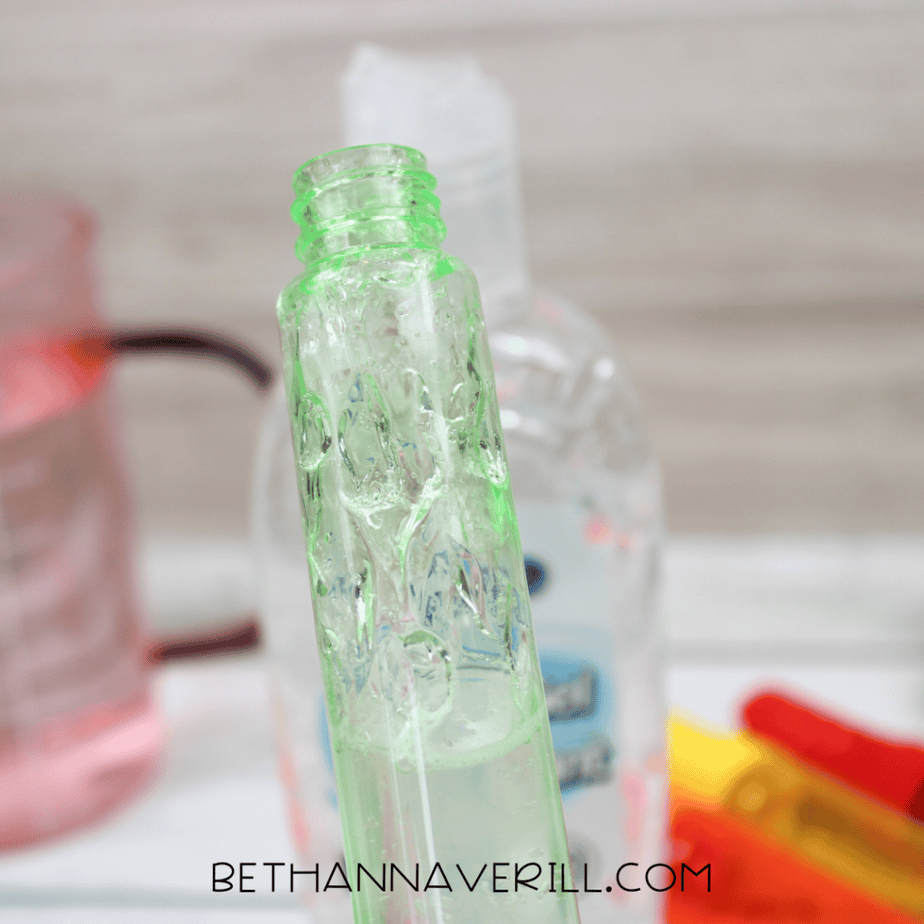 Clear styling gel being poured into a bubble tube for DIY sensory bottle