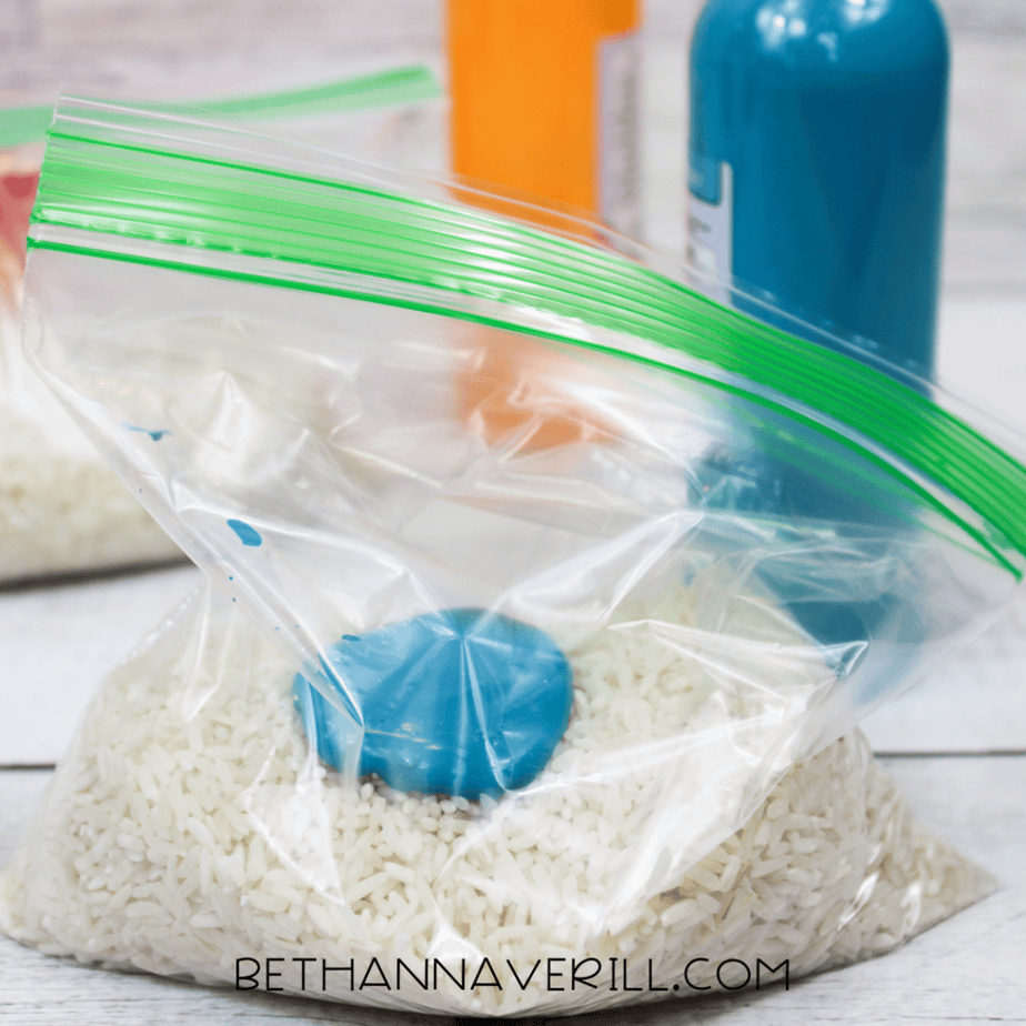 Blue food coloring added to rice inside a ziplock bag