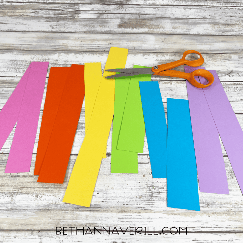 Strips of brightly colored paper cut into long rectangles for the unicorn mane.