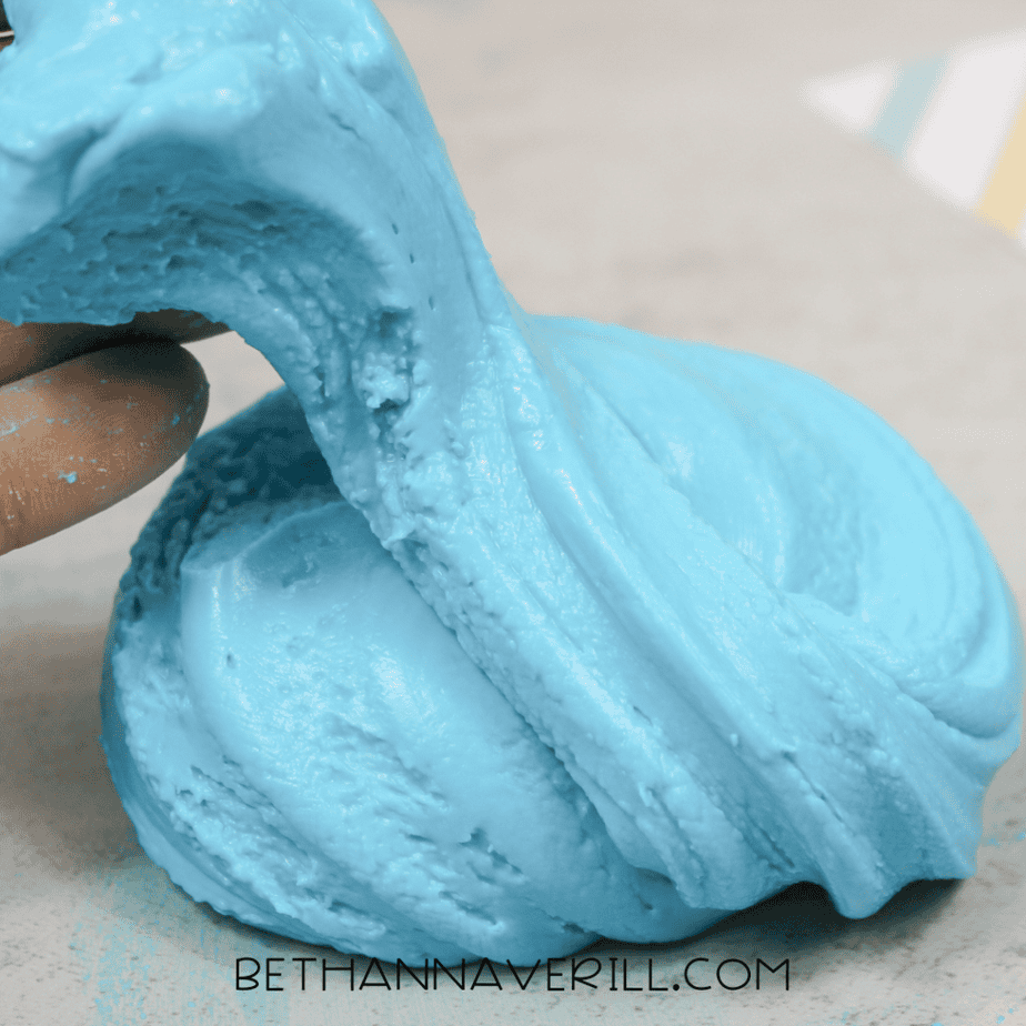 Blue slime folded over itself showing a soft, stretchy texture.