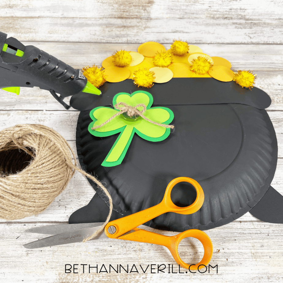Image of twine tied into a bow and attached to the center of the shamrock.