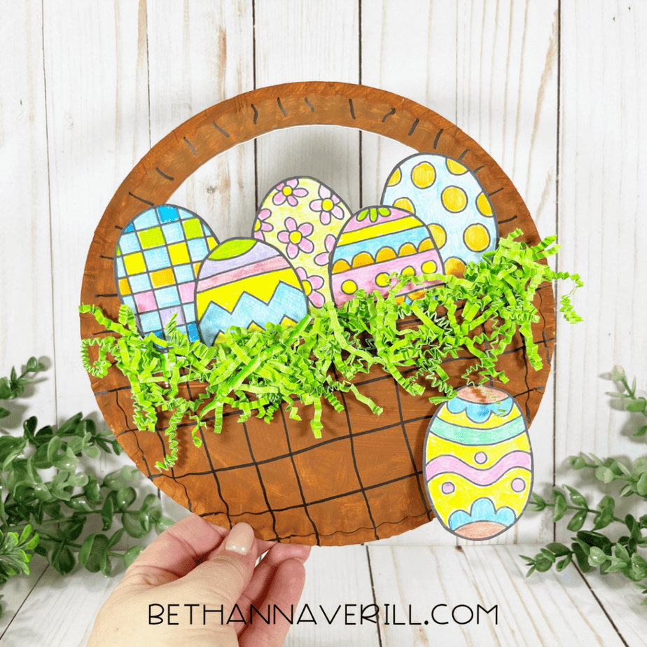 Finished paper plate Easter basket craft with colored eggs and green paper shred