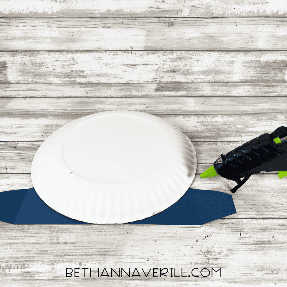 Back view of paper plate glued to the blue hill base.