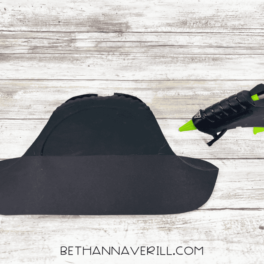 Attaching black cardstock band to paper plate pirate hat.