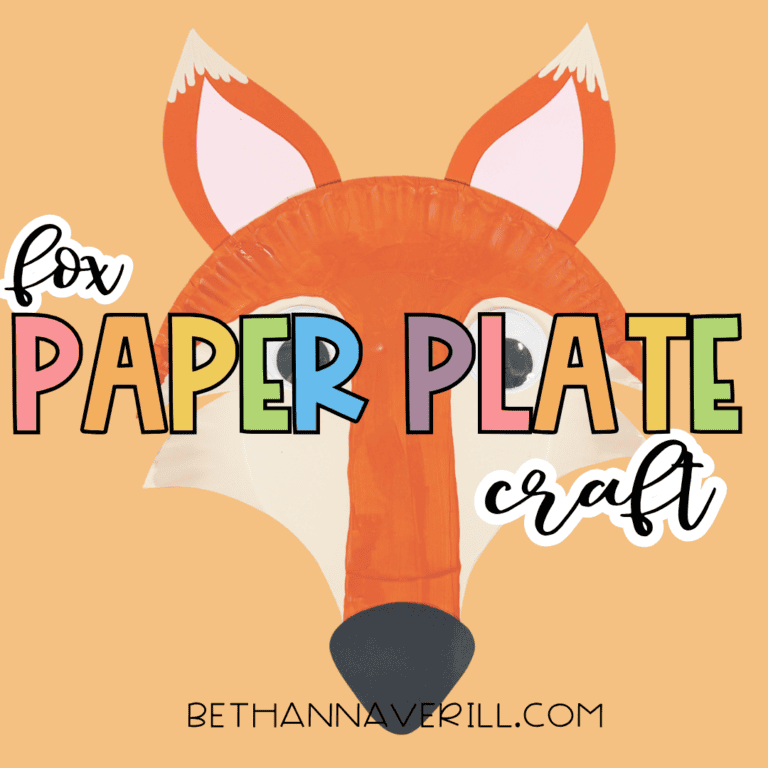 Finished orange paper plate fox craft on a peach background with the words “fox paper plate craft.”